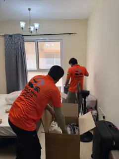 Movers carrying packed goods out of an apartment