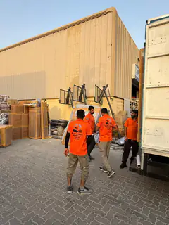 Crates and wrapped goods staged outside the warehouse